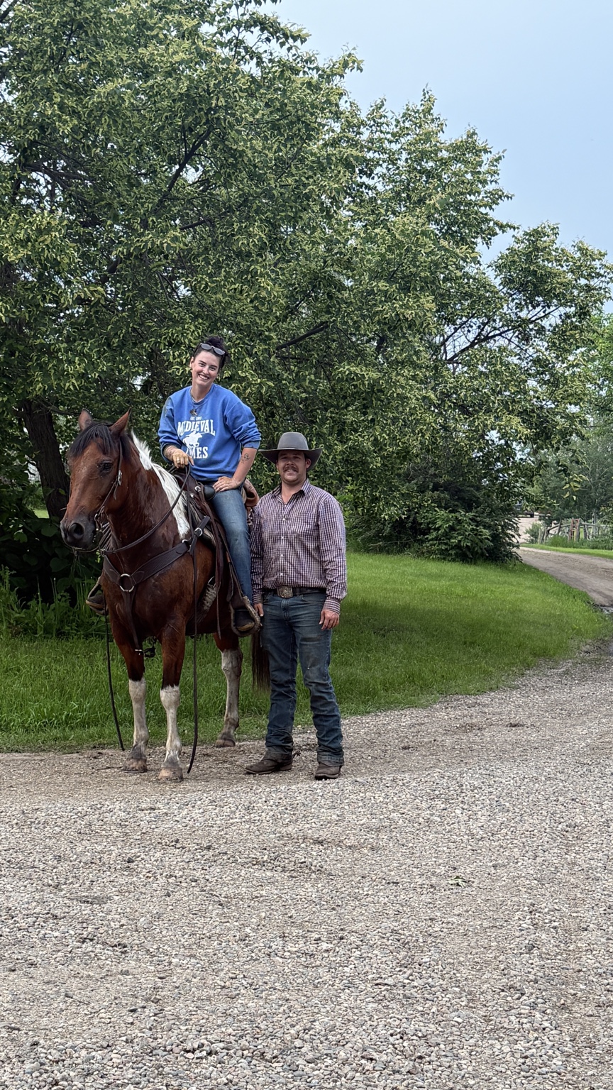 Rylee on horseback beside Colen at the ranch